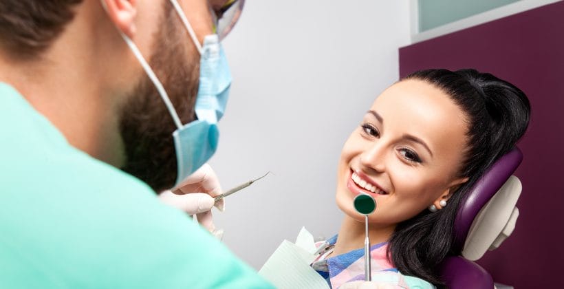 woman smiling before receiving dental work