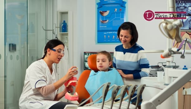 pedia dentist explaining to a young patient